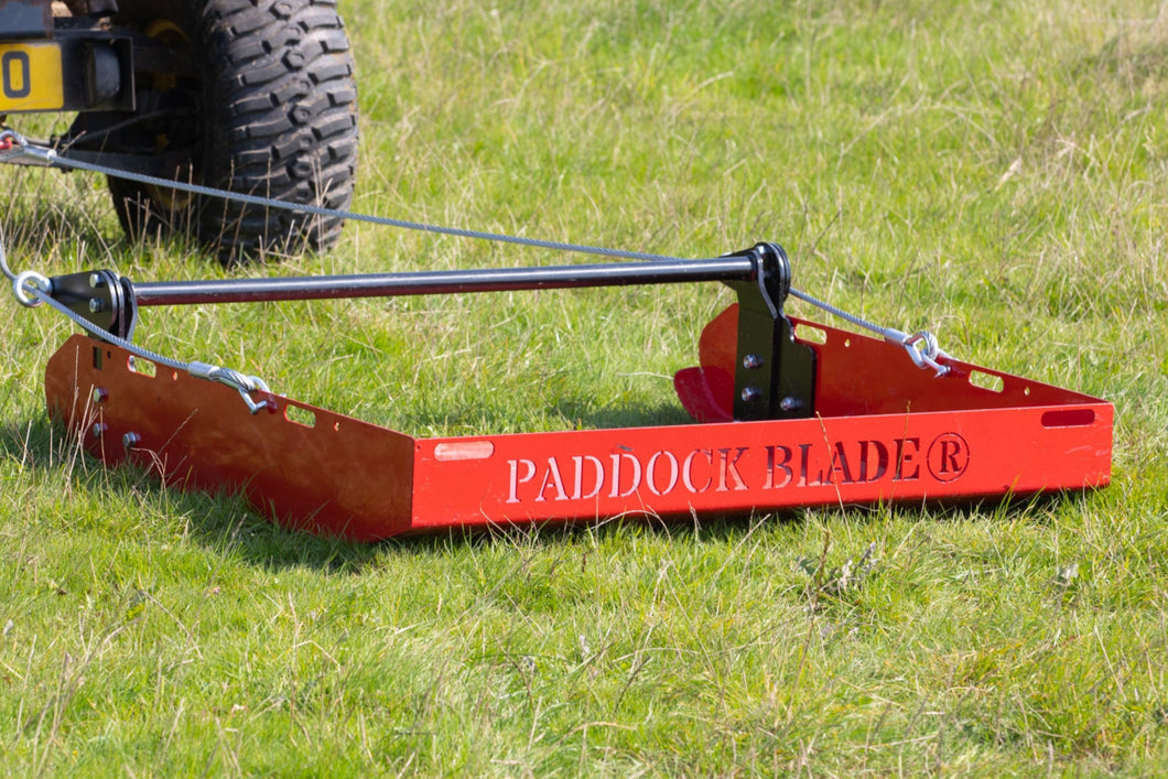 Paddock Blade collecting manure in open paddock with trees in background