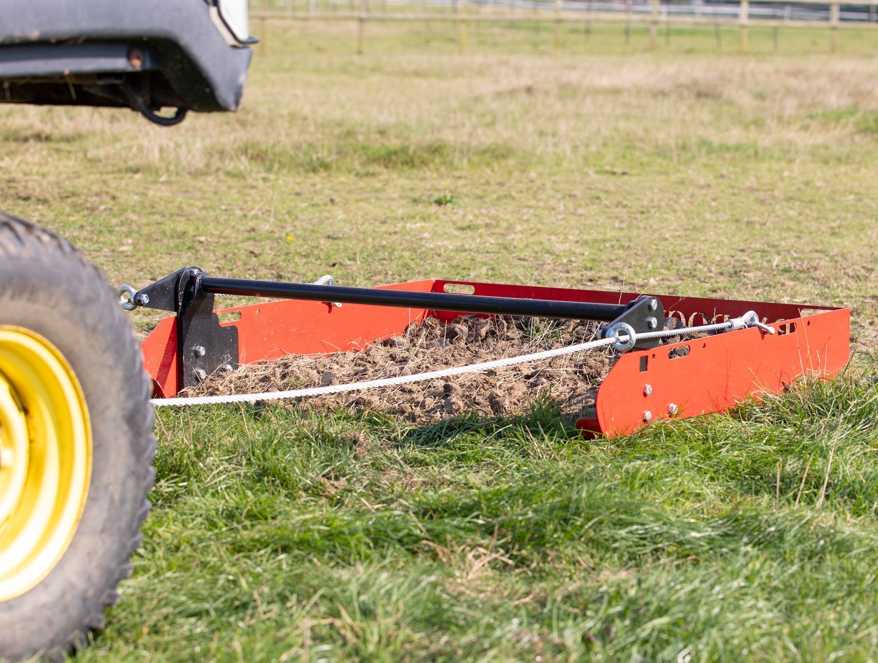Paddock Blade in pasture collecting manure with clear blue sky overhead